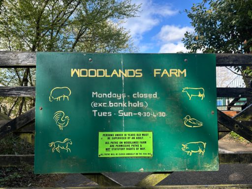 Woodlands Farm Trust London Signboard at Woodlands Farm, detailing opening hours and information about livestock.